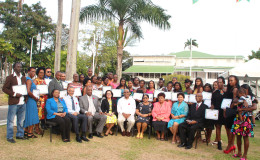 Graduates of the Self-Reliance and Success in Business Workshops pose with President David Granger (centre), First Lady Sandra Granger (on his right), wife of the Prime Minister Sita Nagamootoo (on his left) and other ministers of government.