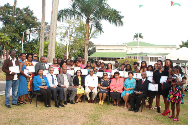 Graduates of the Self-Reliance and Success in Business Workshops pose with President David Granger (centre), First Lady Sandra Granger (on his right), wife of the Prime Minister Sita Nagamootoo (on his left) and other ministers of government.