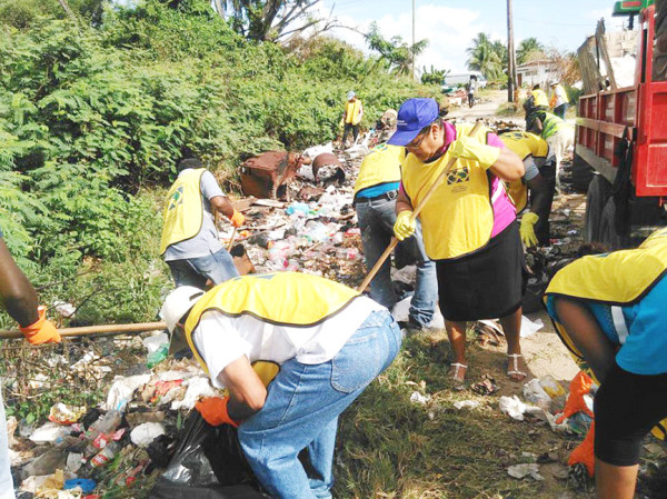 Volunteers from the Church of Jesus Christ of Latter Day Saints and other organisations removing garbage as part of the clean-up activity.