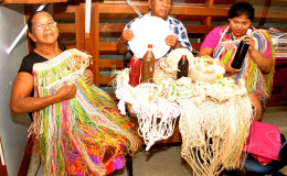 Neville Calistro(The Mighty Chief) and his wife and granddaughter displaying craft and cassava bread at the Stabroek News   earlier this week
