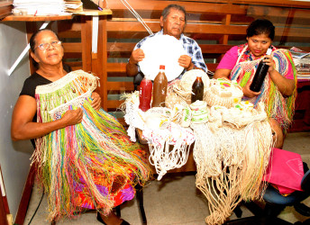 Neville Calistro(The Mighty Chief) and his wife and granddaughter displaying craft and cassava bread at the Stabroek News   earlier this week 