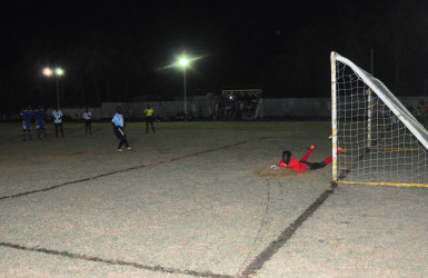 Akini Cameron of Ann’s Grove watches in despair as his penalty kick attempt is denied by the New Amsterdam United keeper during their team’s matchup in the GTT Knockout Championship. (Orlando Charles photo) 