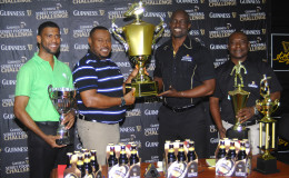 Tourney Coordinator and Petra Organization Co-Director Troy Mendonca (2nd from left) collecting the championship trophy from Guinness Brand Manager Lee Baptiste following the launch of the Guinness of the Streets Georgetown Leg while Banks DIH executives Troy Peters (right) and Errol Nelson look on.