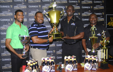 Tourney Coordinator and Petra Organization Co-Director Troy Mendonca (2nd from left) collecting the championship trophy from Guinness Brand Manager Lee Baptiste following the launch of the Guinness of the Streets Georgetown Leg while Banks DIH executives Troy Peters (right) and Errol Nelson look on.