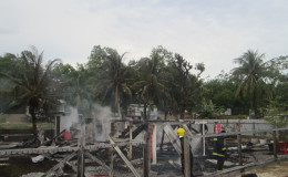 The remains of the two-storey home after firefighters doused the flames which consumed it