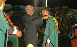 Sachin Ramsuran being conferred with the President’s Medal by President David Granger
