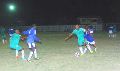 Collie Hercules of Topp XX (green) battling to maintain possession of the ball while being challenged by New Amsterdam United’s Lenardo Adams during their team’s matchup at the No. #5 ground in the GTT Knockout Football Championship. 