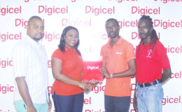 Digicel’s Sponsorship Executive, Luanna Abrams (second from left) hands over the sponsorship package to Principal Assistant Secretary of the Ministry of Finance, Glendon Fogenay as PRO of the National Championships, Edison Jefford (left) and Second Vice-President of the Guyana Teachers Union (GTU) Julian Cambridge look on. (Orlando Charles photo)
