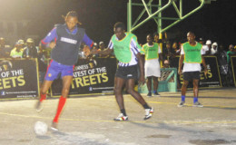 Sparta Boss’s Dennis Edwards (left) trying to maintain possession of the ball while being challenged by a Gold Star player during his side’s win in the Georgetown leg of the Guinness of the Streets at the Burnham Court Tarmac
