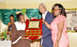 President David Granger presenting the ‘President’s Award for Excellence’ shield to Head Teacher of the Tutorial High School Walterine McLeod and Valedictorian Tonya Browne. The name of this year’s valedictorian and future valedictorians will be inscribed on the shield.  (Ministry of the Presidency photo)