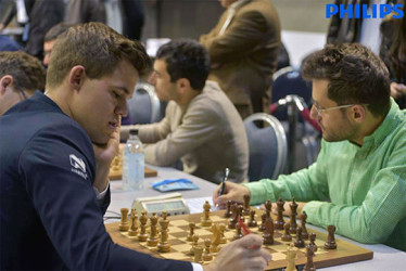 Whenever a world chess champion is defeated by an opponent, the loss makes headlines throughout the chess world. At the 2015 European Team Chess Championship, which concludes today in Reykjavik, Iceland, Armenian grandmaster Levon Aronian clinically outplayed world champion Magnus Carlsen in a magnificent display of tactics. Carlsen grabbed a pawn and was forced on the defensive from which he never recovered. In photo: Carlsen (left) concentrates on his score sheet as Aronian records his move. Carlsen also resigned against Switzerland’s Yannick Pelletier.