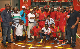 Captain of the Banks DIH Phillip Rowley receiving the championship trophy from the Minster of Foreign Affairs Carl Greenidge following their hard-fought win over the Ministry of Foreign Affairs in the final of the inaugural Banks Beer Inter-Corporation Futsal event