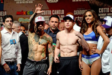Miguel Cotto (left) and Canelo Alvarez (right) pose for a photo during weigh-ins for their upcoming WBC middleweight title fight at Mandalay Bay. Mandatory Credit: Joe Camporeale-USA TODAY Sports. 