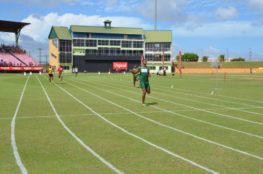 Jason Yaw cruising home in the boys’ under-20 400m heat yesterday at the National Stadium. 