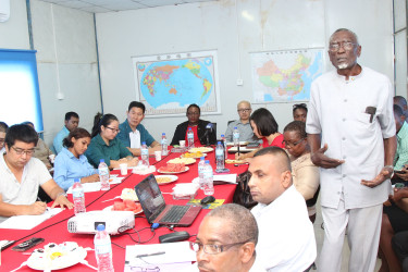 Bailiang Chu, General Manager of Baishanlin to the left of Labour Minister Simona Broomes (centre) and Kevin Liu CHEC’s MovieTowne’s Project Manager to the right of the minister attentively listen to Labour Consultant Francis Carryl’s very animated presentation on charges faced by delinquent employers who circumvent labour laws. 