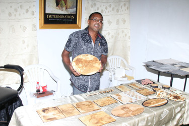 Chhman Sukhaa, of Wooden Memories, displays one of his creations at the Business Exposition 2015, which opened yesterday at the National Exhibition Centre, at Sophia. (Photo by Keno George)