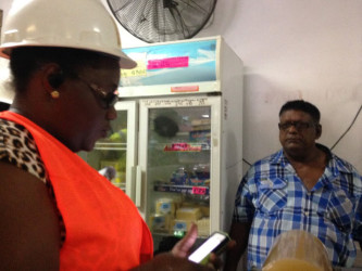 Junior Social Protection Minister Simona Broomes speaks with the owner of the M Ali and Sons Supermarket