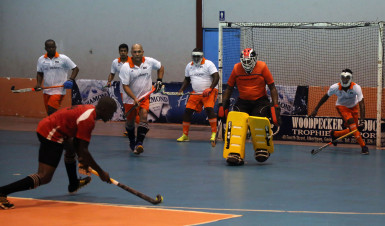 Old Fort’s Aderemi Simon (centre) in the process of attempting a penalty corner strike while GCC try desperately to thwart his effort during their team’s matchup in the Diamond Mineral Water Hockey Festival at the National Gymnasium 