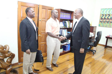 GFF 1st Vice President, Brigadier (rtd.) Bruce Lovell (centre) meets Minister of State Joseph Harmon (right) in the presence of President of the GFF Wayne Forde (Photo courtesy of the Ministry of the Presidency)     