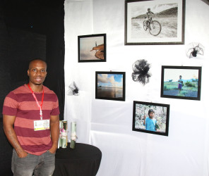 Photographer Brian Gomes showcases some of his other framed photos which were on sale at his booth at the Business Expo. 