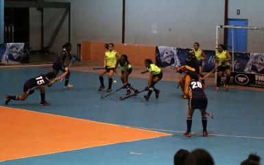  Sonia Jardine (centre) of Pizza Hut GCC in the process of scoring a penalty corner during her side’s crushing win over Hikers in the Diamond Mineral Water Hockey Festival at the National Gymnasium.
 