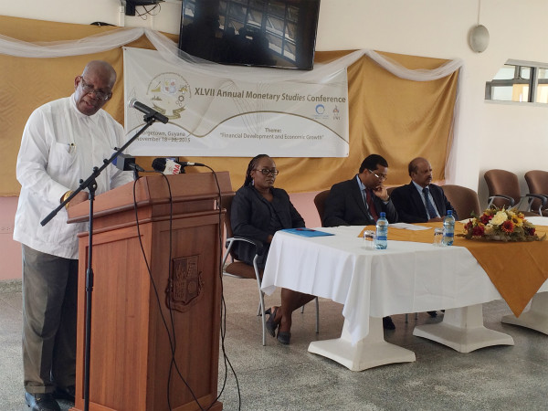 Minister of Finance Winston Jordan (left) addressing the 47th Annual Monetary Studies Conference which was held yesterday at the Bank of Guyana. Seated at right is Governor of the Bank of Guyana, Gobind Ganga.