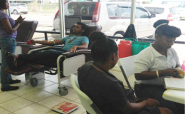 Staff of the blood bank engaging with donors (Massy Industries photo)