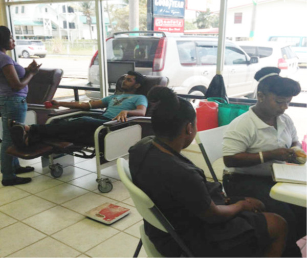Staff of the blood bank engaging with donors (Massy Industries photo)