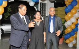 Prime Minister Moses Nagamootoo (left) and his wife Sita being escorted on Friday by President of the Guyana Bar Association Christopher Ram to the GBA/Guyana Association of Women Lawyers dinner at the Georgetown Club.
