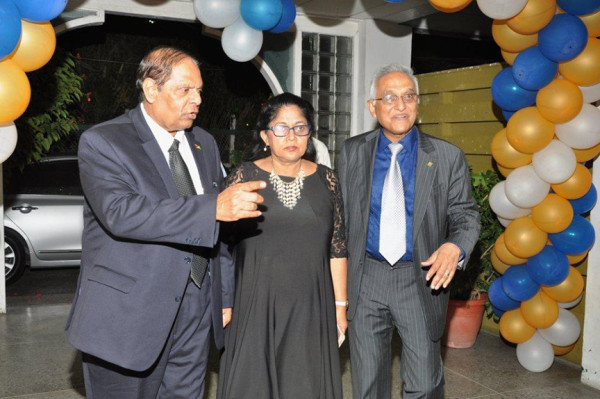Prime Minister Moses Nagamootoo (left) and his wife Sita being escorted on Friday by President of the Guyana Bar Association Christopher Ram to the GBA/Guyana Association of Women Lawyers dinner at the Georgetown Club.