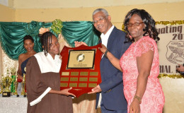 President David Granger presenting the 'President's Award for Excellence' shield to Head Teacher of the school, Walterine McLeod and Valedictorian, Tonya Browne. The name of this year's valedictorian and future valedictorians will be inscribed on the shield.  (Ministry of the Presidency photo)