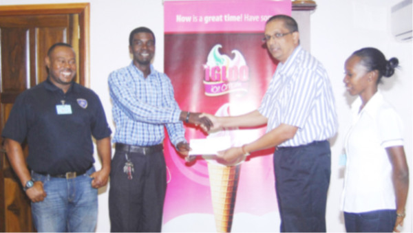 Petra Organization representative Mark Alleyne collecting the sponsorship cheque from Sterling Products Managing Director Ramsay Ali (2nd from right) while Petra Organization Director Troy Mendonca (left) and President of the Guyana Women’s Association Charmaine Wade look on.