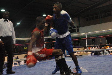 Guyana’s Tefon Green about to floor Trinidad and Tobago’s Anthony Joseph in their flyweight match up on Sunday night