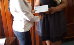 Mohini Somaroo (left) Company Secretary/ Corporate Manager of GNSC Ltd presenting the cheque to Deputy Town Clerk S Jerrick.