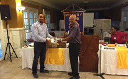 Dr Kenneth Jainandan (left) handing over the supplies to Ron Robinson