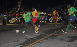 Jamal Haynes of West Back Road (second from left) battling with a North Ruimveldt player for possession of the ball during the latter’s round-of-16 win in the Guinness of the Streets Georgetown Championship at the National Cultural Centre Tarmac
