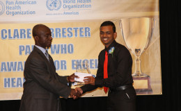 Stabroek News Reporter David Papannah collecting his prize for Best News Story Online.