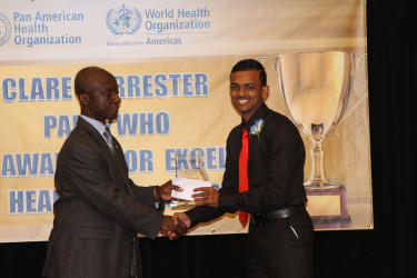 Stabroek News Reporter David Papannah collecting his prize for Best News Story Online.