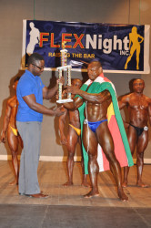 Mr Flex Night 2015 Wendel Sedro of Suriname collecting his winner’s trophy from president of the GABBFF Keavon Bess