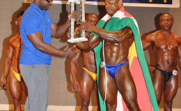 Mr Flex Night 2015 Wendel Sedro of Suriname collecting his winner’s trophy from president of the GABBFF Keavon Bess