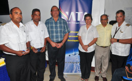 Recipients Captain Gary Sahai (left), Supervisor of Operations Bholanauth Baijnath (second, left) and Director of Aviation Safety Regulations Ankar Doobay pose with NATA President Annette Arjoon-Martins (third, right), Vice President, Captain Gerry Gouveia (right) and Vice Chairman of the Private Sector Commission Edward Boyer (second, right).