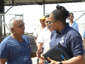 Minister Annette Ferguson (right) speaking to a resident. (Ministry of Public Infrastructure photo) 