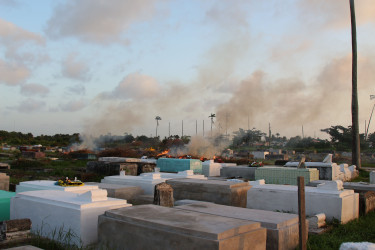 Debris being burned in Le Repentir Cemetery. (Photo by Keno George)