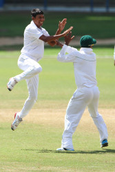 Gudakesh Motie celebrates with Leon Johnson after he took a wicket (WICB photo)  