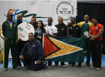 Guyana’s medal heist squad posing with the Golden Arrowhead at the 6th Commonwealth Powerlifting Championships which concluded in Vancouver, Canada on Sunday.