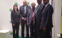 Minister Raphael Trotman (second from left) with the team from Global Green Initiative after the signing. (Ministry of the Presidency photo)
