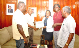 GCAG representatives receiving their Certificate of Registration from Minister Simona Broomes.
