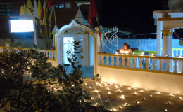 A Hindu devotee lighting diyas at a mandir in East Canje