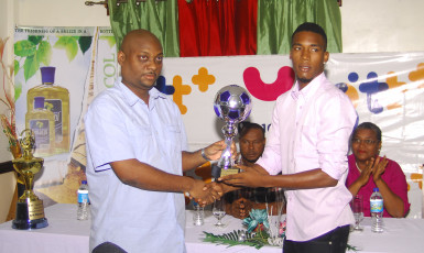 Clarence Huggins (right) of Milerock FC collecting his Most Valuable Player accolade from Limacol Finance Director Duane Lovell during the official Limacol/GTT Football Championship presentation ceremony.