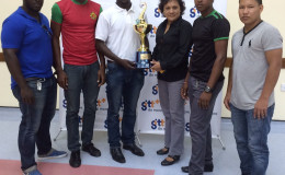 Second VP of the GRFU, Joshua Griffith pose with the GTT 10s championship trophy in the presence of the captains of The Pepsi Hornets, GDF, UG Wolves and the GPF. 